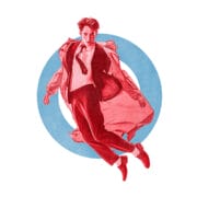 A man in a suit and coat is mid-jump in front of a large blue circle on a white background.
