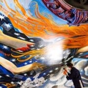 A conservator undertakes the restoration of a vibrant, swirling ceiling mural by John Byrne at King’s Theatre, featuring stars, flames, clouds, and outstretched human limbs.