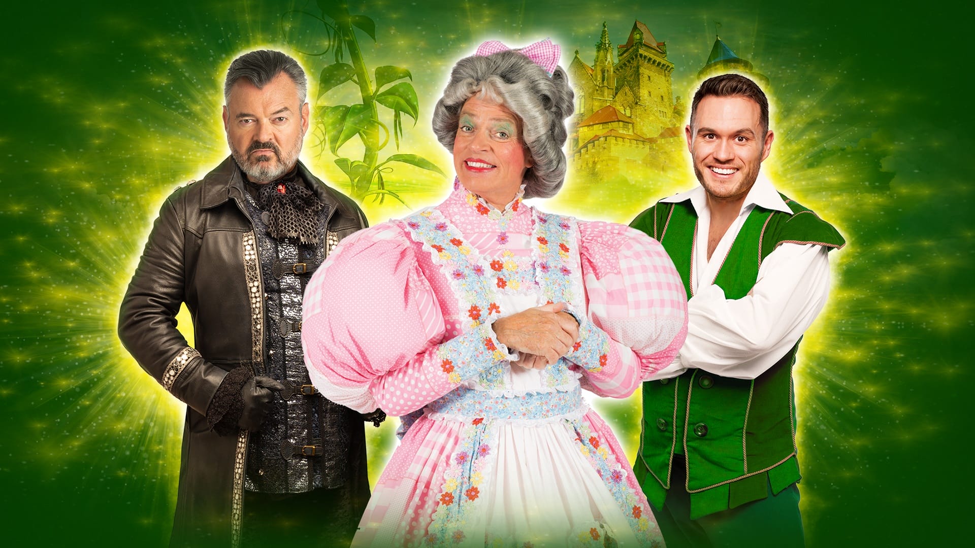 Three people in costume pose in front of a green, fantasy-themed background: one in a dark coat, one in a pink plaid dress and wig, and one in a green vest and white shirt.