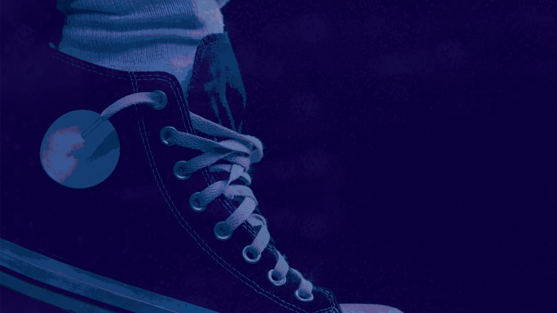 Close-up of a person wearing a lace-up sneaker with a blank circular tag attached to one eyelet, shown in blue and purple tones.