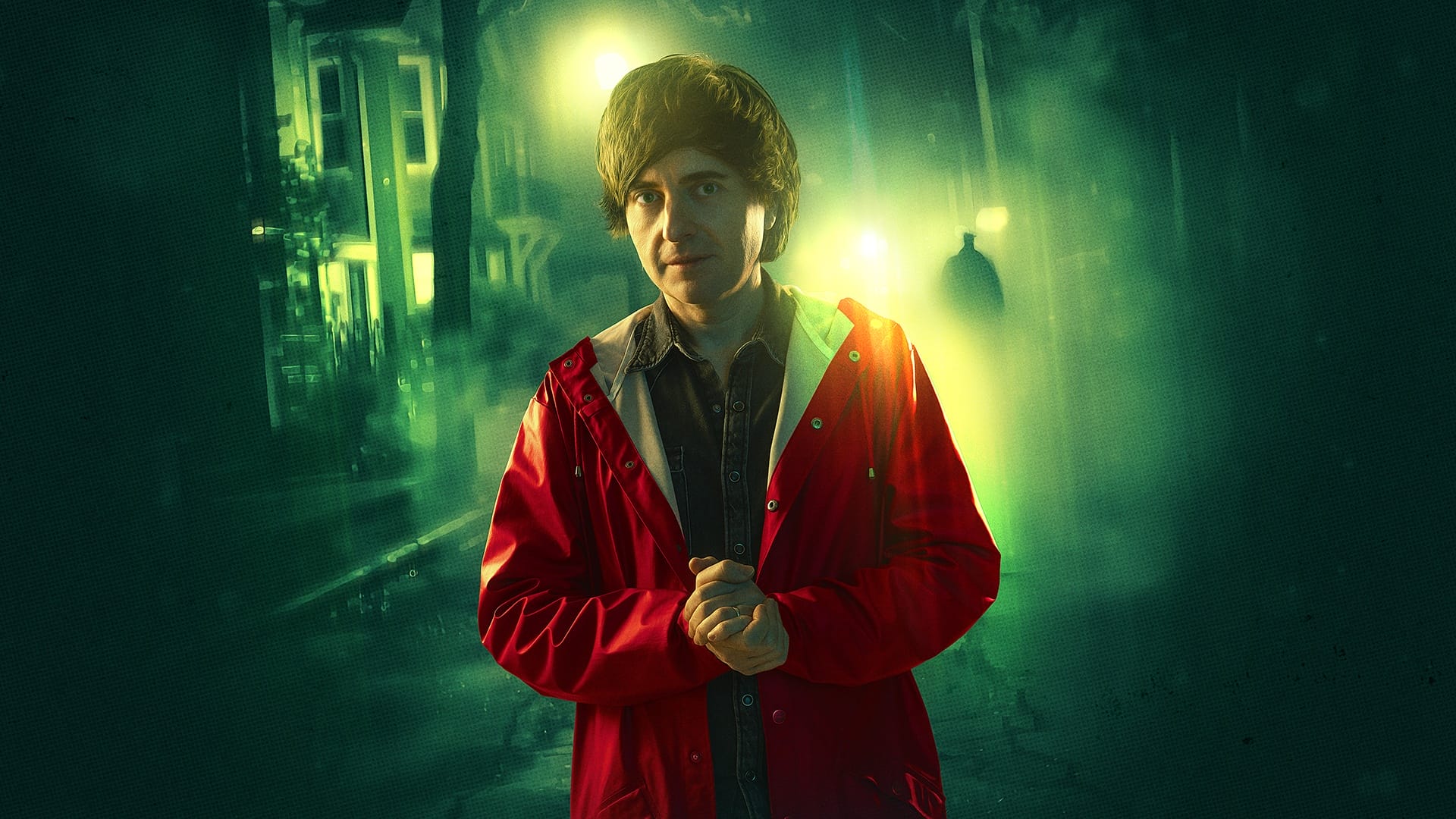 A man in a red raincoat stands on a dimly lit street at night, with greenish streetlights and a shadowy figure in the background.