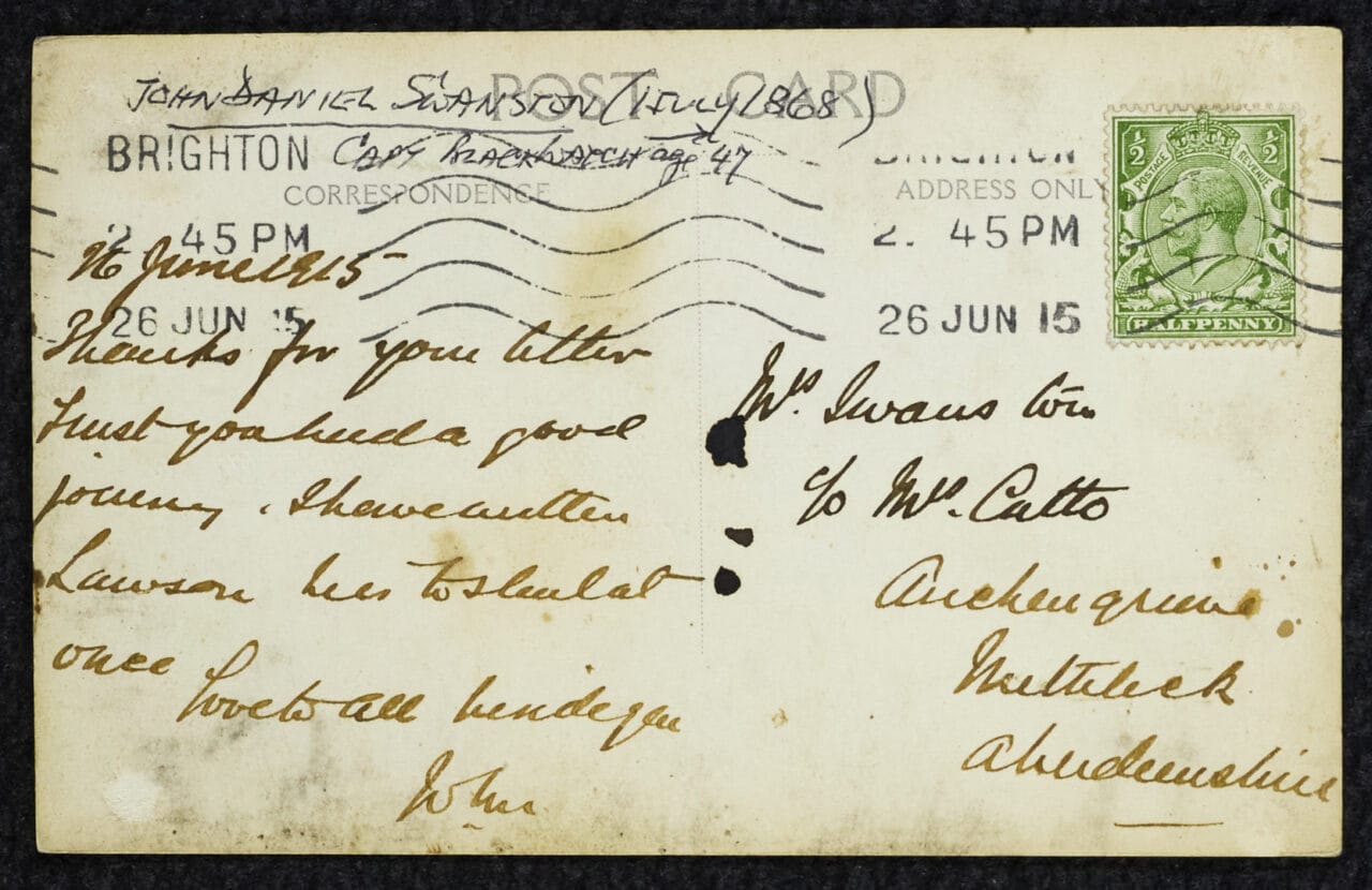 The rear of the postcard features handwritten text, a green postage stamp, postal markings, and addresses on both sides.