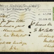 The rear of the postcard features handwritten text, a green postage stamp, postal markings, and addresses on both sides.