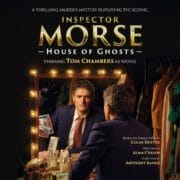 A man in a suit sits at a dressing table, surrounded by theater lights and costumes, gazing into the mirror; "Inspector Morse: House of Ghosts" promotional text overlays the image.