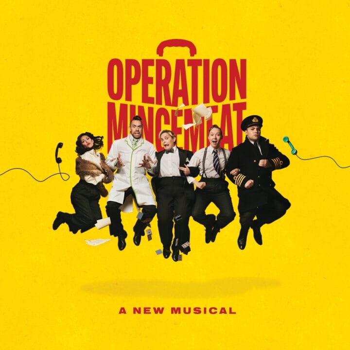 Five actors in various costumes leap in front of a yellow backdrop, with "Operation Mincemeat: A New Musical" boldly displayed above them.