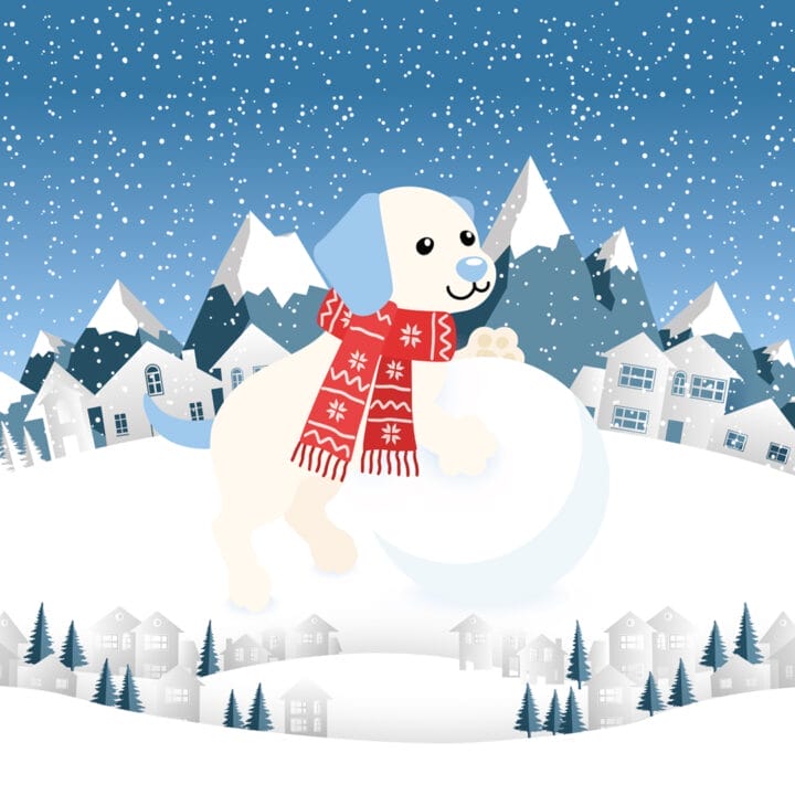 Cartoon dog wearing a red winter scarf stands on a large snowball in a snowy landscape with houses, trees, and mountains in the background. Snow is falling from the sky.