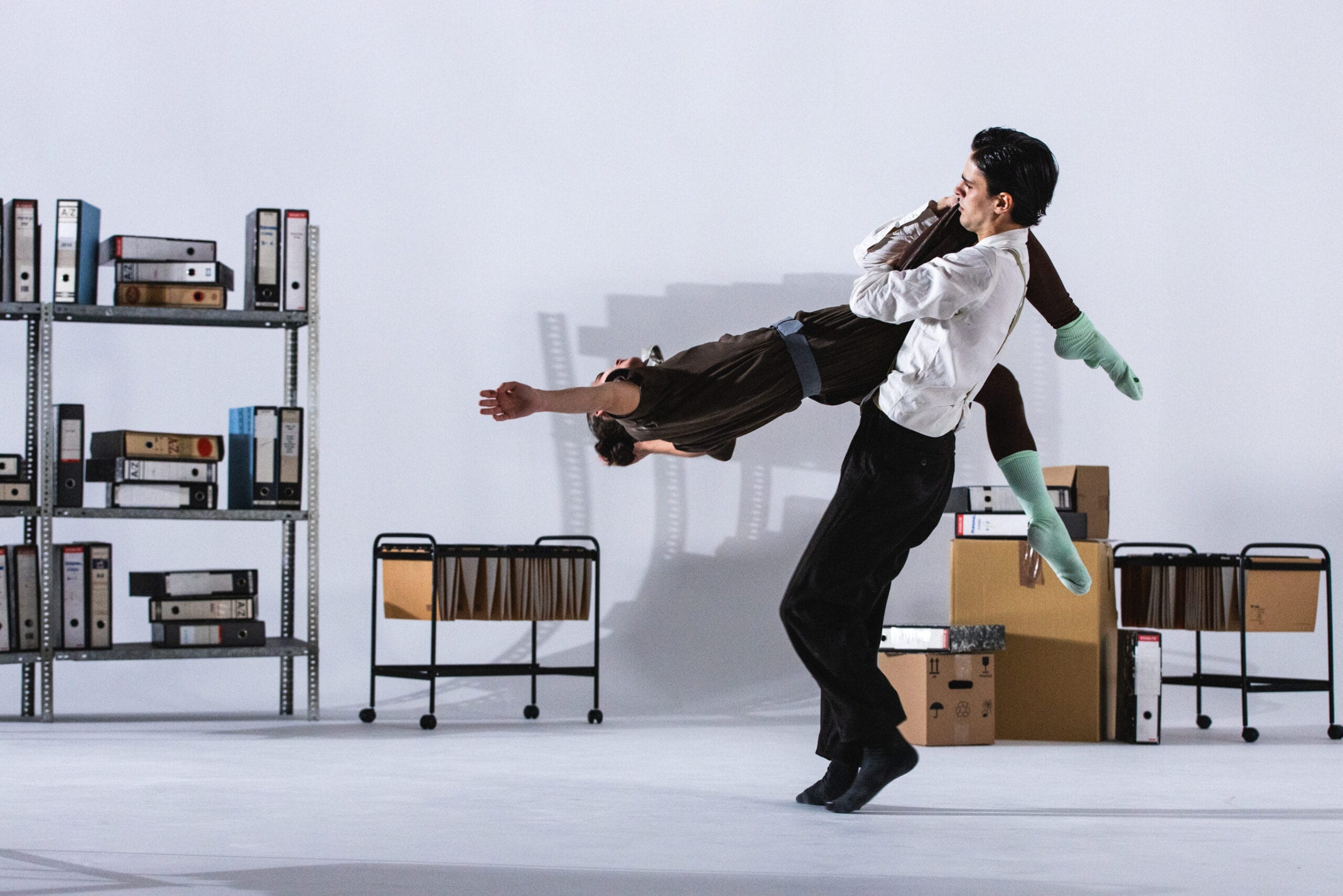 A man carrying a woman in the air.