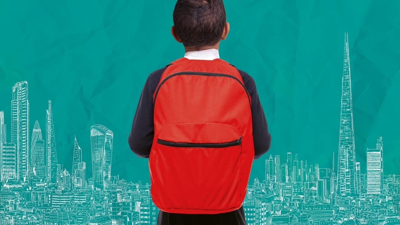 A child with a red backpack stands facing a teal background with white illustrated city buildings and skyscrapers, evoking the spirit of Onjali Q. Raúf's beloved children's book, The Boy at the Back of the Class.