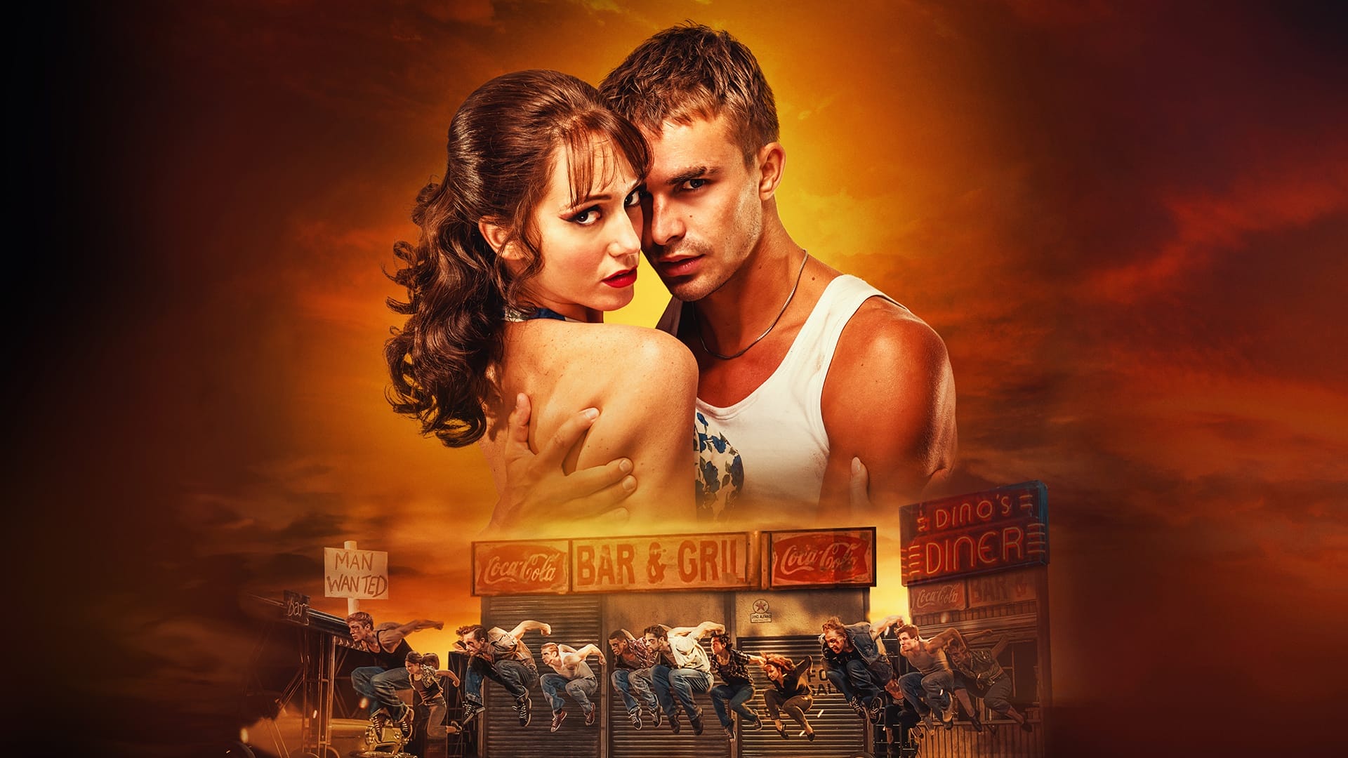 A man and woman embrace in front of a dramatic orange sky, with a group of dancers performing in front of a bar and diner at the bottom of the image.