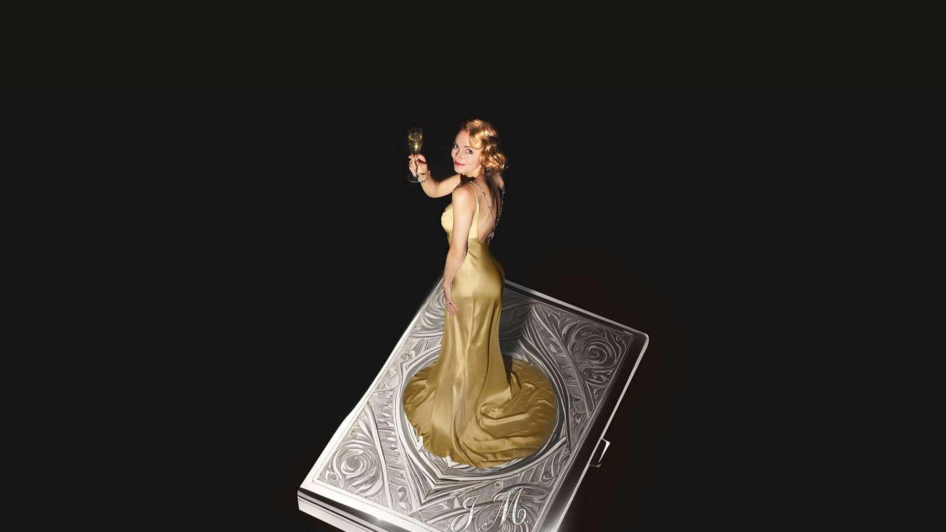 A woman in a gold dress, evoking a scene from The Constant Wife, holds a drink and stands on a large, ornate silver rectangular object against a black background.