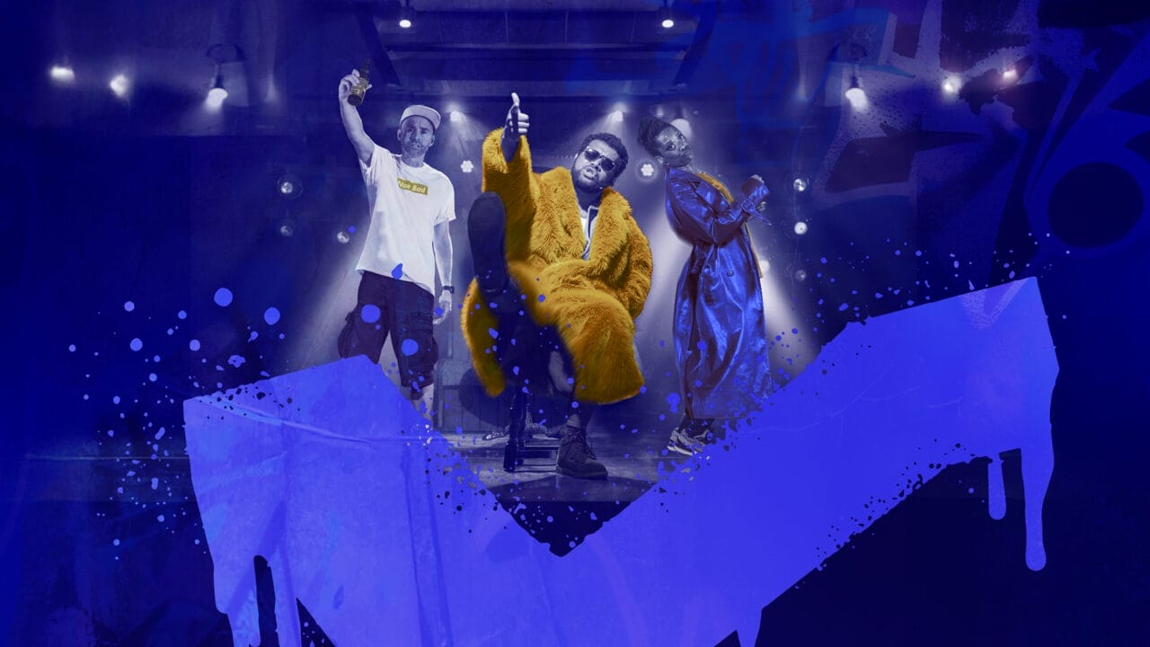 Three people pose in hip hop rap posture, hands in the air, over a blue background with Scottish saltire flag spray painted like graffiti