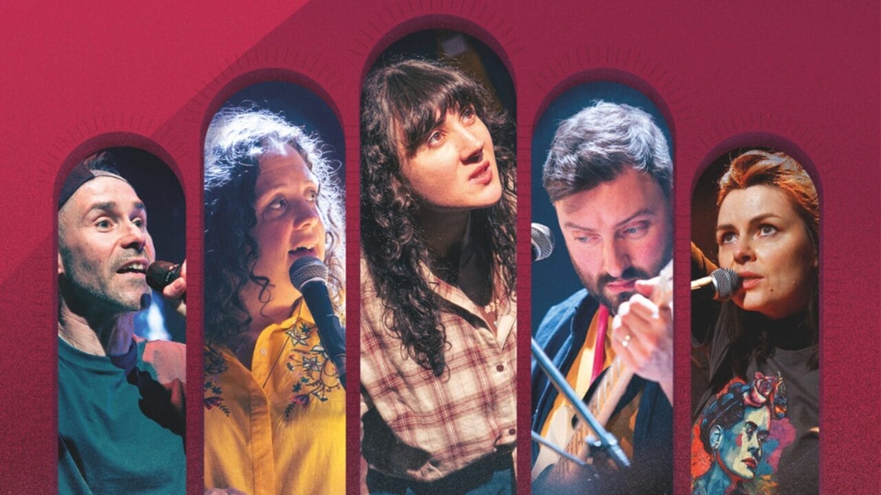 Five musicians perform on stage, each holding a microphone, framed by arched designs and a bold red background that creates a giant bridge of energy between the performers and the audience.