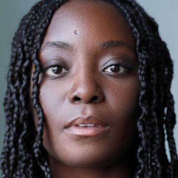Trudy Akobeng, a black woman with long braided hair