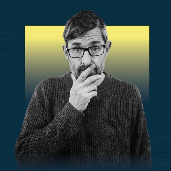 Louis Theroux, a middle aged man with a beard and glasses, looking inquisitive