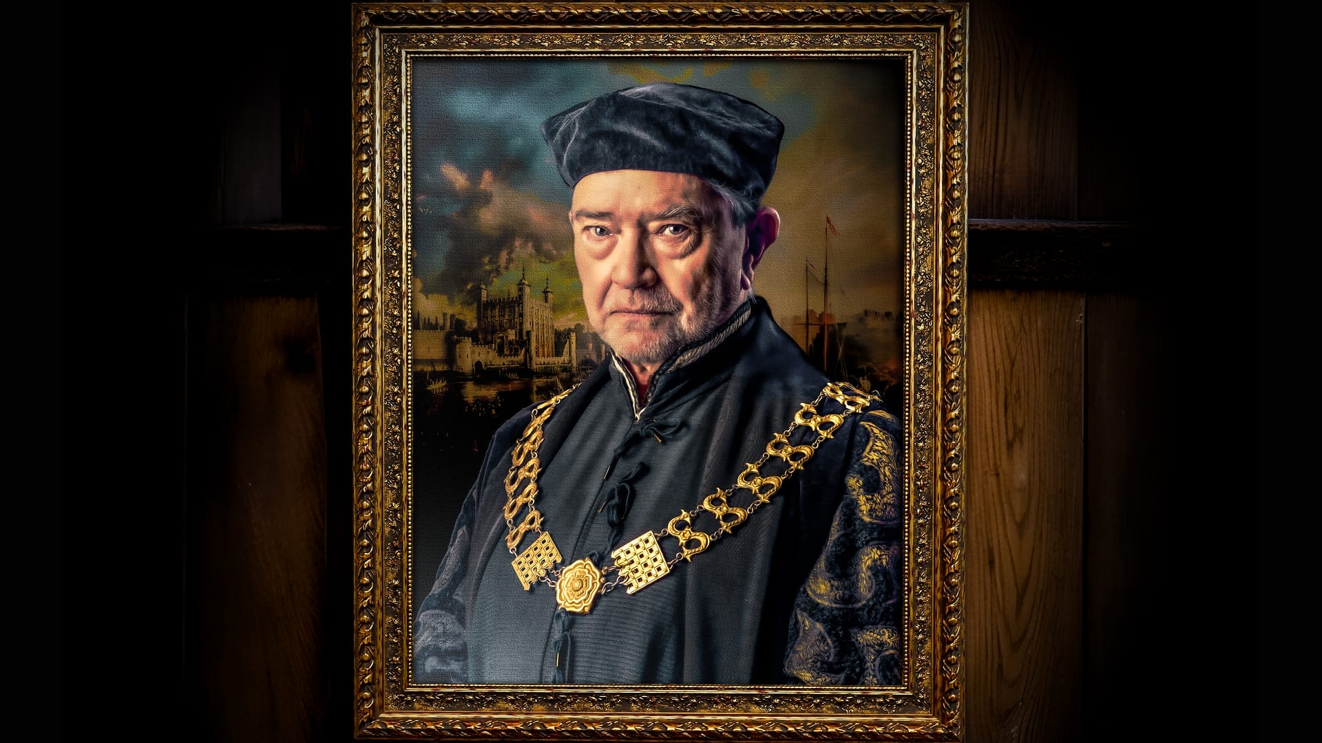 A framed portrait of an older man, reminiscent of A Man For All Seasons, wearing a black hat and elaborate dark clothing with a large gold chain, set against a dramatic background. The ornate frame features intricate decorative patterns.